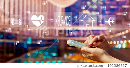 Insurance concept with person using a smartphone in city at night 102386837