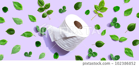 A roll of toilet paper with green leaves 102386852