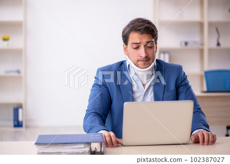 Young male employee after car accident at workplace 102387027
