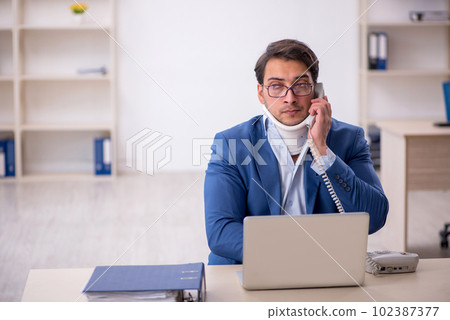 Young male employee after car accident at workplace 102387377