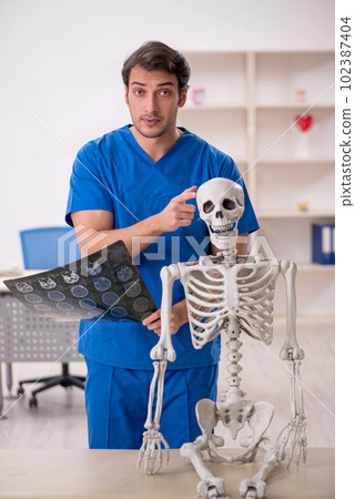 Young male doctor and skeleton patient in the clinic Young male doctor and skeleton patient in the clinic 102387404