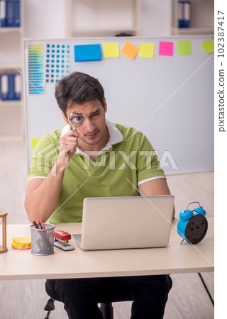 Young male designer sitting in the office 102387417