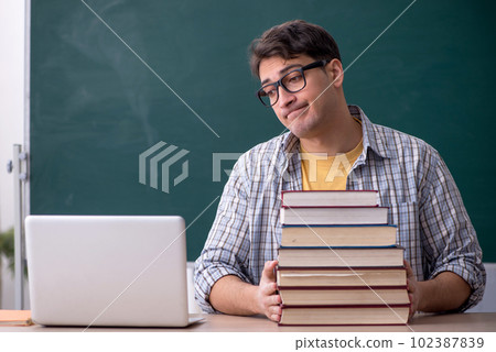 Young male student preparing for exams in the classroom 102387839