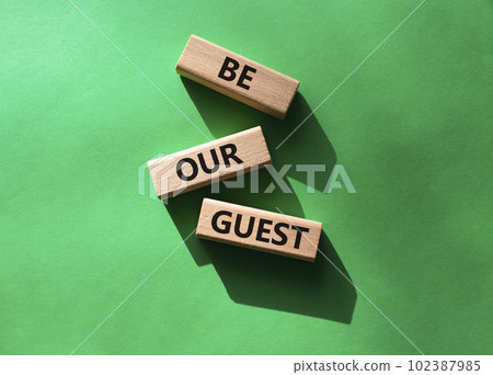 Be our guest symbol. Concept word Be our guest on wooden blocks. Beautiful green background. Business and Be our guest concept. Copy space Be our guest symbol. Concept word Be our guest on wooden blocks. Beautiful green background. Business and Be our guest concept. Copy space 102387985