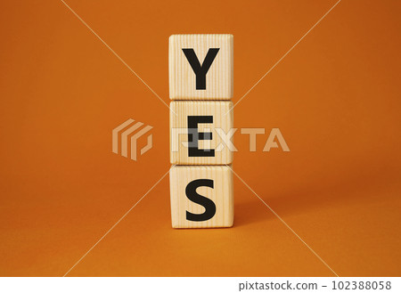 Yes symbol. Wooden blocks with word yes. Beautiful orange background. Business and yes concept. Copy space. 102388058