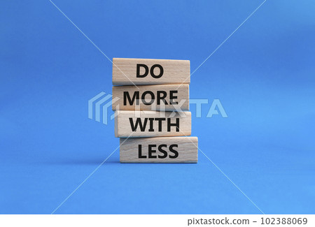 Do more with less symbol. Concept words Do more with less on wooden blocks. Beautiful blue background. Business and Do more with less concept. Copy space. Do more with less symbol. Concept words Do more with less on wooden blocks. Beautiful blue background. Business and Do more with less concept. Copy space. 102388069