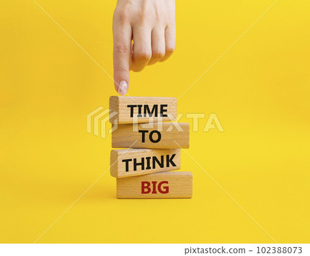 Time to think big symbol. Wooden blocks with words Time to think big. Beautiful yellow background. Businessman hand. Business and Time to think big concept. Copy space. 102388073