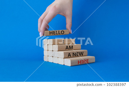 Hello I am a new hire symbol. Concept words Hello I am a new hire on wooden blocks. Beautiful blue background. Businessman hand. Business and Hello I am a new hire concept. Copy space. Hello I am a new hire symbol. Concept words Hello I am a new hire on wooden blocks. Beautiful blue background. Businessman hand. Business and Hello I am a new hire concept. Copy space. 102388397
