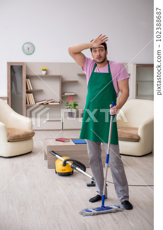 Young male contractor cleaning the house 102388687