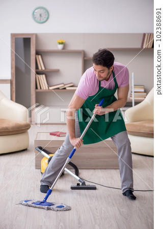 Young male contractor cleaning the house 102388691