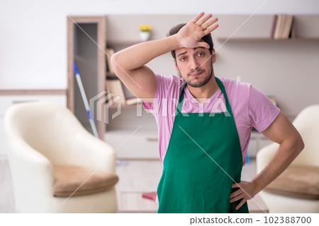 Young male contractor cleaning the house 102388700