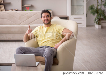 Young man working from home during pandemic Young man working from home during pandemic 102388764