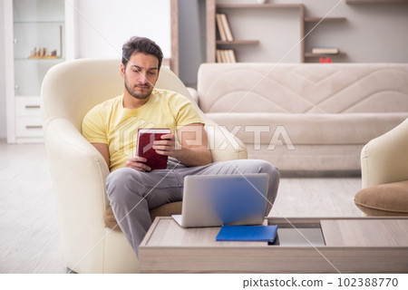 Young man working from home during pandemic 102388770