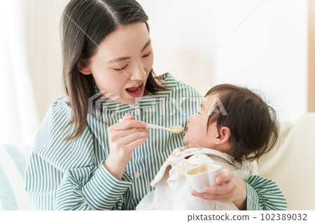 Baby eating baby food Baby eating baby food 102389032