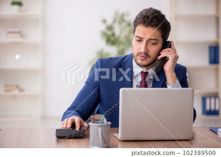 Young male employee working in the office 102389500