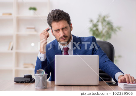 Young male employee working in the office Young male employee working in the office 102389506