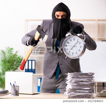 Male gangster stealing information from the office 102389601