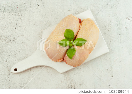 Raw fresh chicken leg meat with skin and with fresh herbs on a gray background.Copy space.Food for retail.Procurement for designers.Ogranic food,healthy eating.Food concept.Top view.Chicken leg meat. Raw fresh chicken leg meat with skin and with fresh herbs on a gray background.Copy space.Food for retail.Procurement for designers.Ogranic food,healthy eating.Food concept.Top view.Chicken leg meat. 102389944