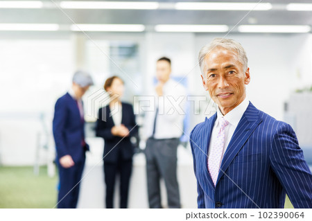 A businessman standing in the office A businessman standing in the office 102390064
