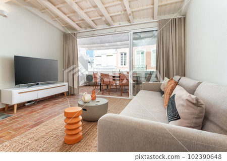 Modern minimalist living room with wooden ceilings and balcony view. 102390648