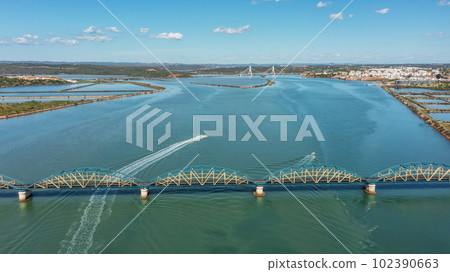 Portuguese bridge over the river Arade the city of Portimao. Ponte Velha old bridge. boats sail by  102390663