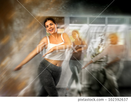 Positive women engaged in active dancing 102392637