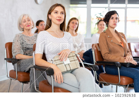 small group of female students attentively listens to teacher s speech. Advanced training 102392638