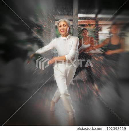 Elderly woman dancing in fitness studio 102392639
