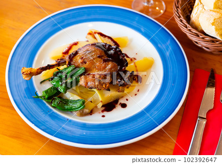 Duck confit in port with pear chutney 102392647