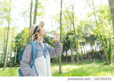 Portrait of senior woman drinking water 102392658