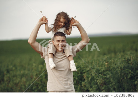 Family in a summer park. Father in a white t-shirt. Cute little daughter 102393902