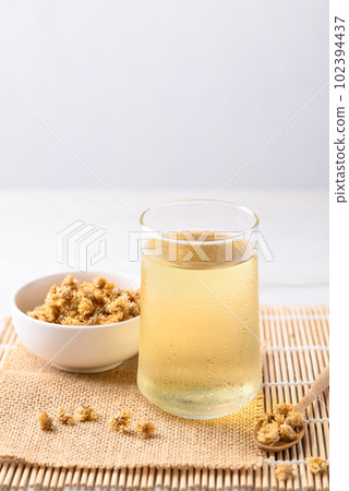 Chrysanthemum tea in glass and dry flowers, Healthy Herbal drink 102394437