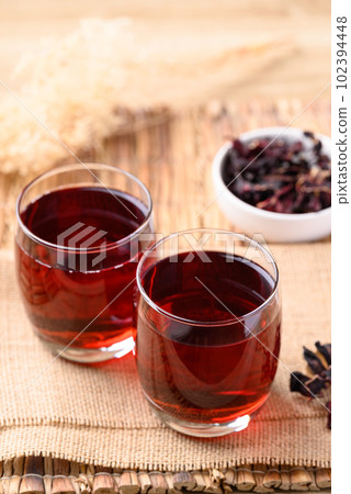 Roselle tea in glass with dried roselle, Herbal drink for reduction in blood pressure Roselle tea in glass with dried roselle, Herbal drink for reduction in blood pressure 102394448