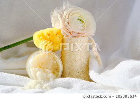 Scrub, loofah washcloth and organic sea sponge on the towel. 102395634