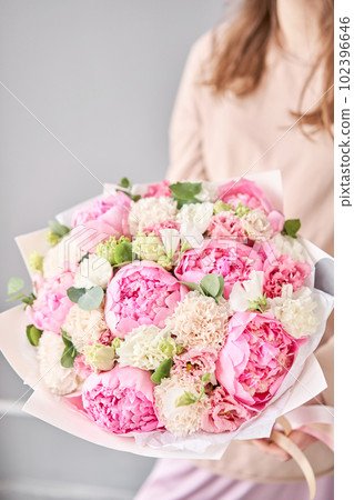 Floral shop concept . Handsome fresh bouquet. Flowers delivery. Beautiful bouquet of mixed flowers in woman hand. Floral shop concept . Handsome fresh bouquet. Flowers delivery. Beautiful bouquet of mixed flowers in woman hand. 102396646
