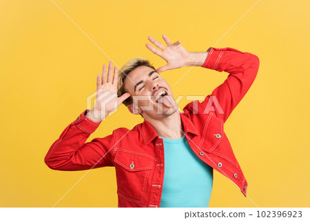 Gay man grimacing and joking with tongue out 102396923