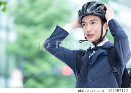 騎自行車通勤戴頭盔的年輕人 騎自行車通勤戴頭盔的年輕人 102397113