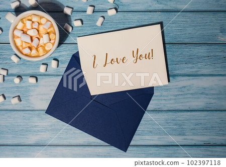 I LOVE YOU text on valentine card inscription positive quote phrase Greeting card blue envelope with white cup of coffee and marshmallows on wooden blue background holiday I LOVE YOU text on valentine card inscription positive quote phrase Greeting card blue envelope with white cup of coffee and marshmallows on wooden blue background holiday 102397118