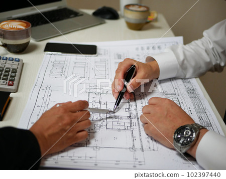 An architect who works while discussing in a meeting An architect who works while discussing in a meeting 102397440