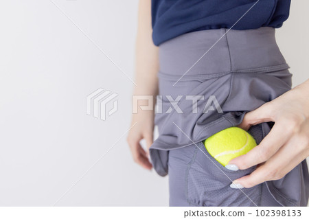 Tennis woman ball hiding place 102398133