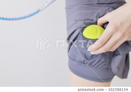 Tennis woman ball hiding place 102398134
