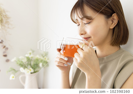 A woman drinking tea 102398160