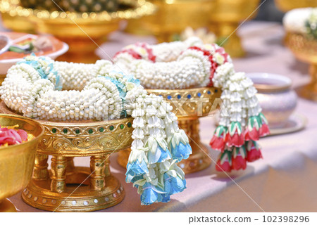 Jasmine garland on golden tray, respect and worship 102398296