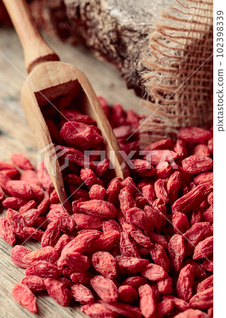 Dried goji berries on a wooden table. 102398339