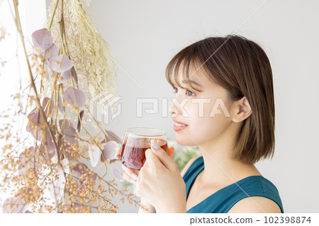 A woman drinking tea A woman drinking tea 102398874