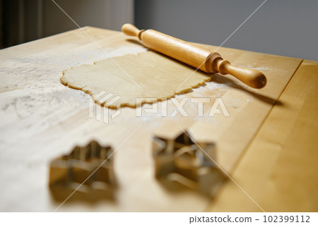 Flat dough on the table and rolling pin Flat dough on the table and rolling pin 102399112