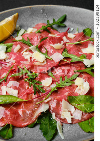 Marbled beef carpaccio on black background, closeup Marbled beef carpaccio on black background, closeup 102399124