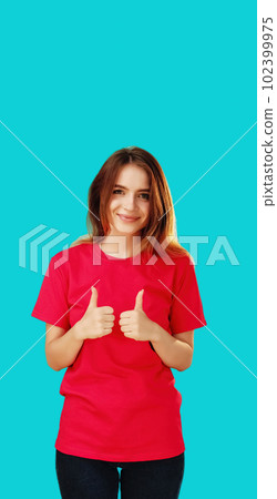 Thumbs up gesture. Approval sign. Right choice. Happy smiling woman in red T-shirt showing like hand symbol isolated on cyan blue copy space background. Thumbs up gesture. Approval sign. Right choice. Happy smiling woman in red T-shirt showing like hand symbol isolated on cyan blue copy space background. 102399975