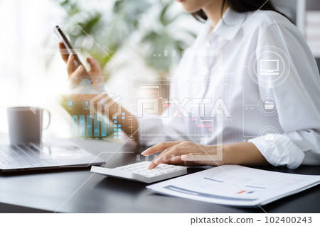 Business woman hand Project manager working and update tasks and Gantt chart scheduling virtual diagram.with smart phone, tablet and laptop in office. Business woman hand Project manager working and update tasks and Gantt chart scheduling virtual diagram.with smart phone, tablet and laptop in office. 102400243