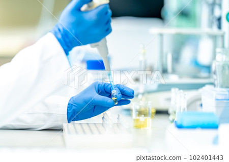pipetting of chemical samples during research in a biochemical scientific laboratory pipetting of chemical samples during research in a biochemical scientific laboratory 102401443